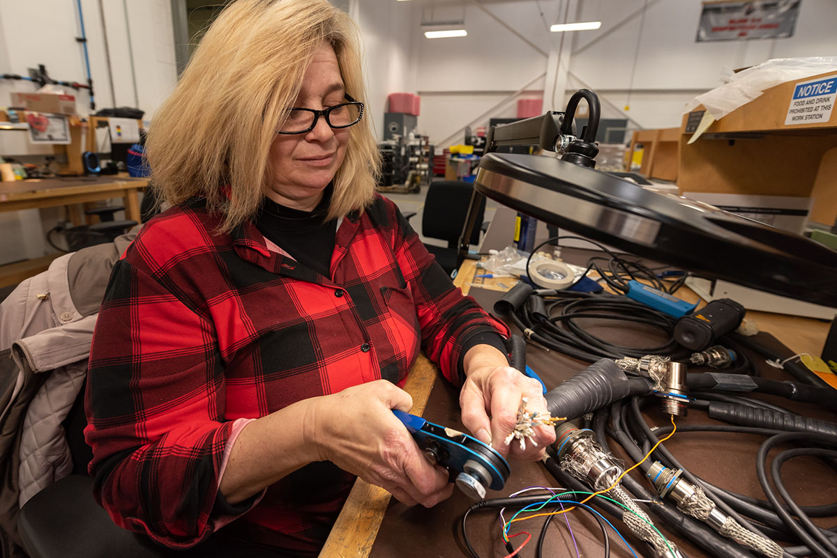 Photo of person working on cable