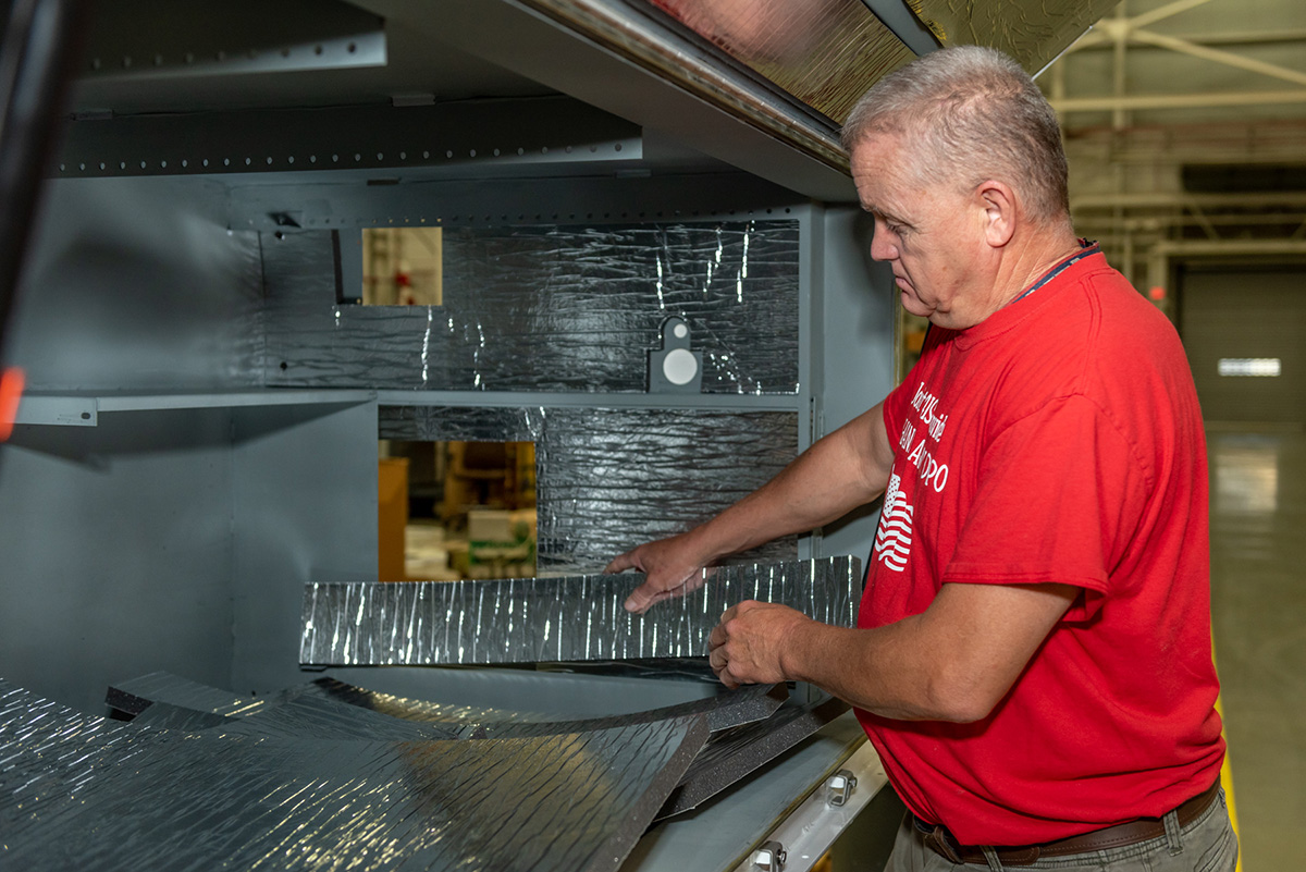 Photo of employee installing insulation